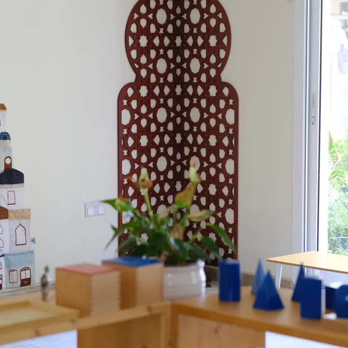 A wooden mashrabiya screen and materials by the window