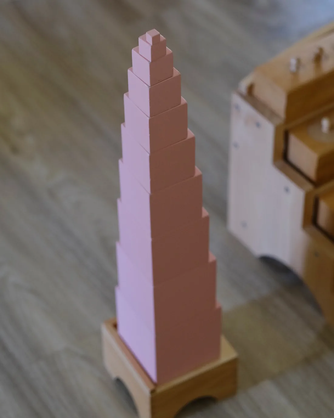 A Montessori pink tower, one of the hands-on materials children master at their own pace