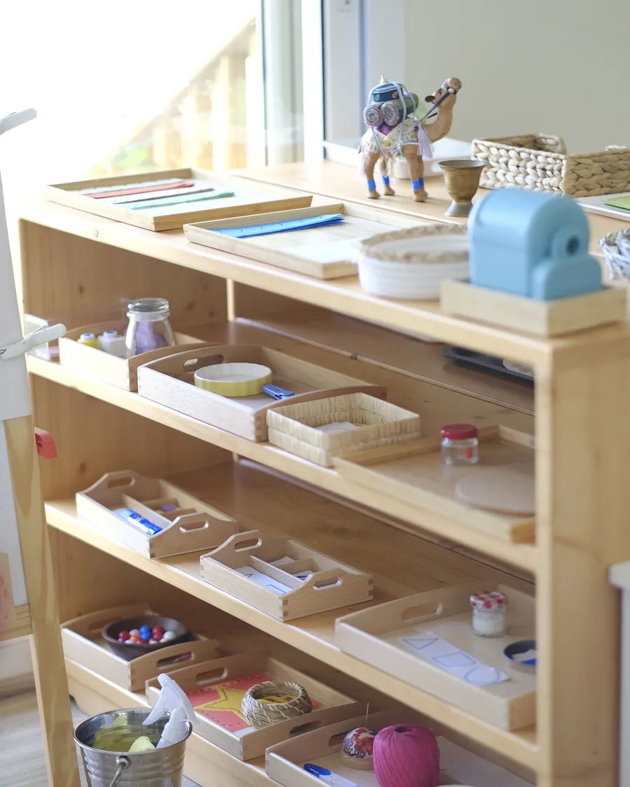 Montessori practical-life materials on open shelves